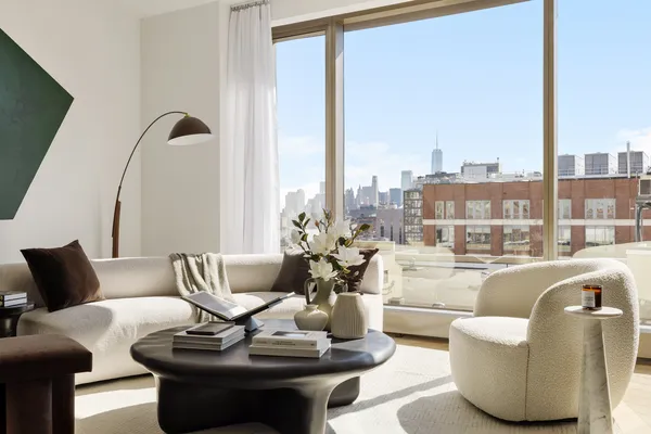 a living room with furniture and floor to ceiling windows