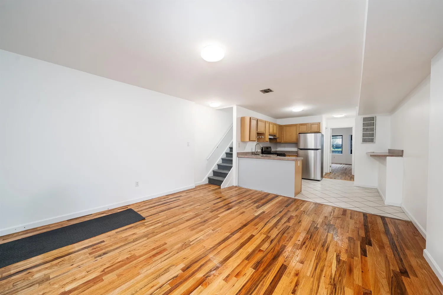 a view of a kitchen with wooden floor