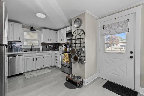 a kitchen with white cabinets and white appliances