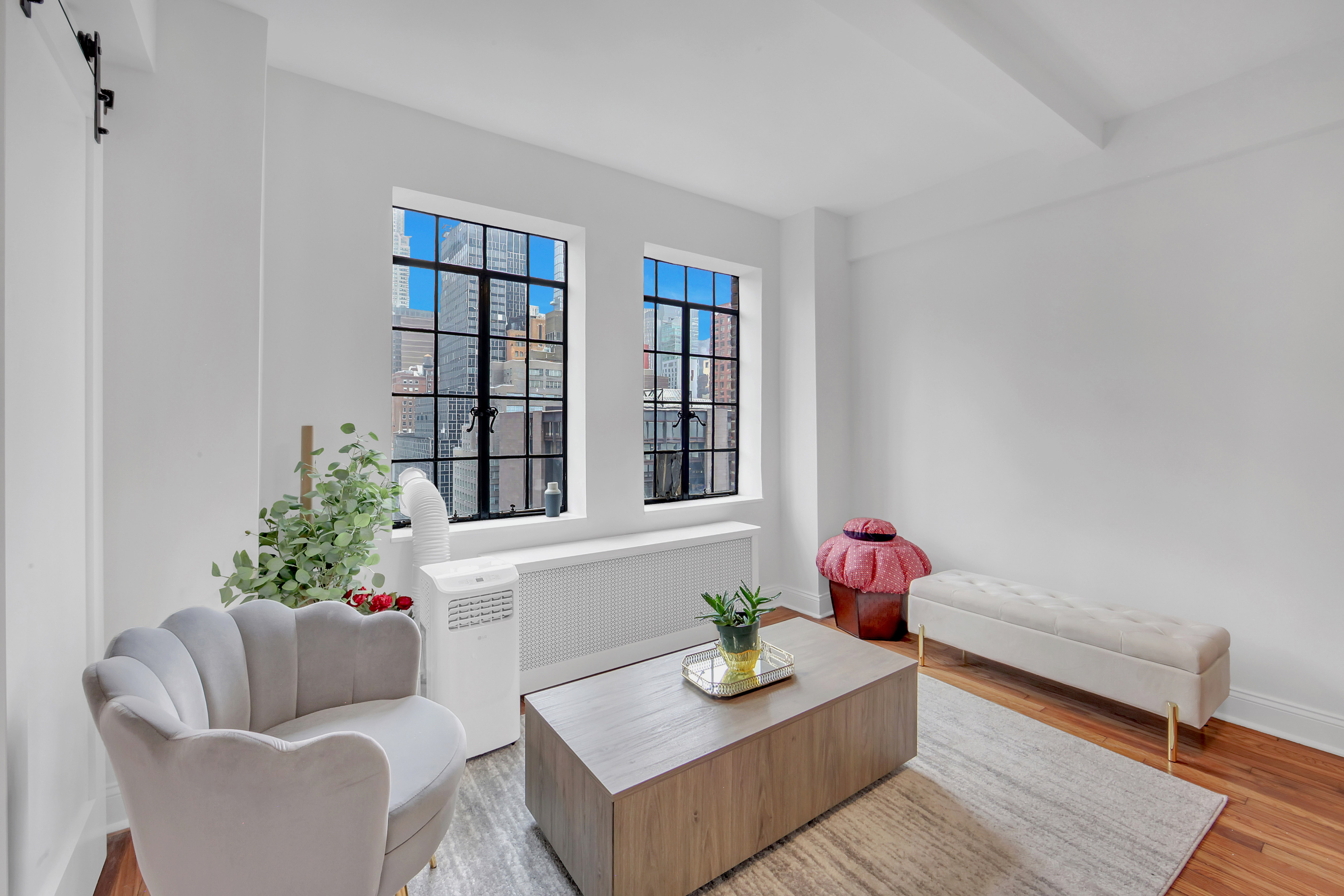 25 Tudor City Place, Unit 1405 Manhattan, NY 10017 - Photo 11 of 21 a living room with furniture and flowers