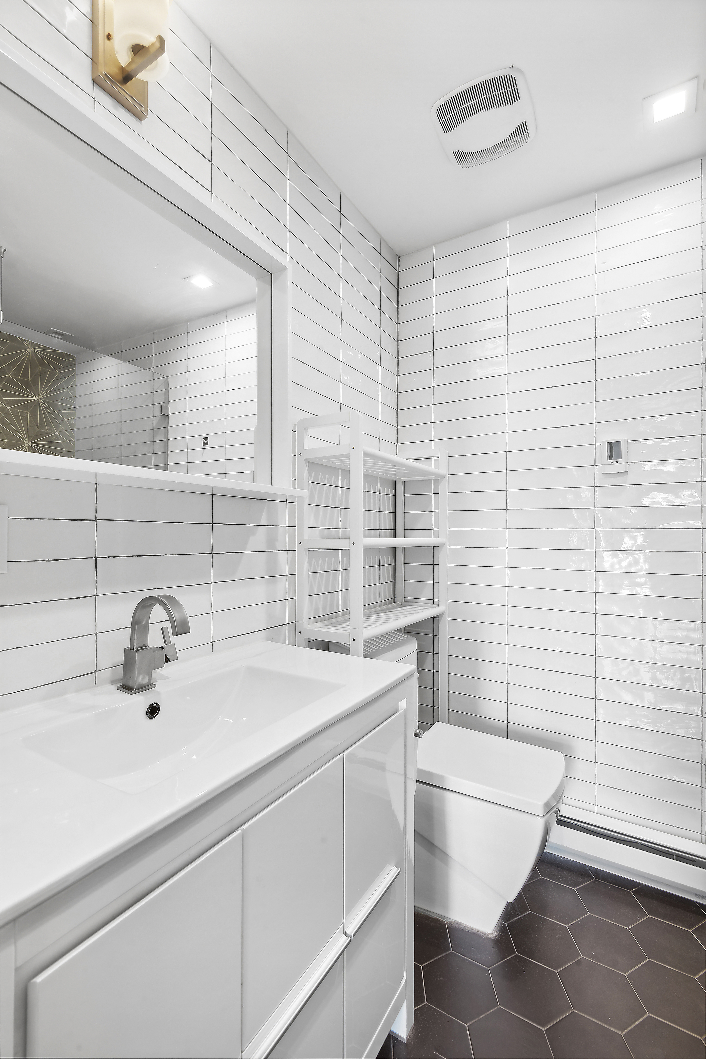 27 Dodworth Street, Unit PHF Brooklyn, NY 11221 - Photo 13 of 18 a bathroom with a sink a toilet and mirror