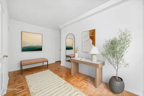 a living room with a couch and a potted plant