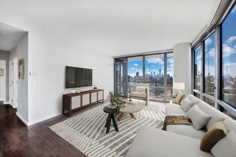 a living room with furniture a flat screen tv and a large window