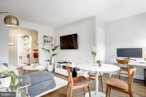 a dining room with furniture and window