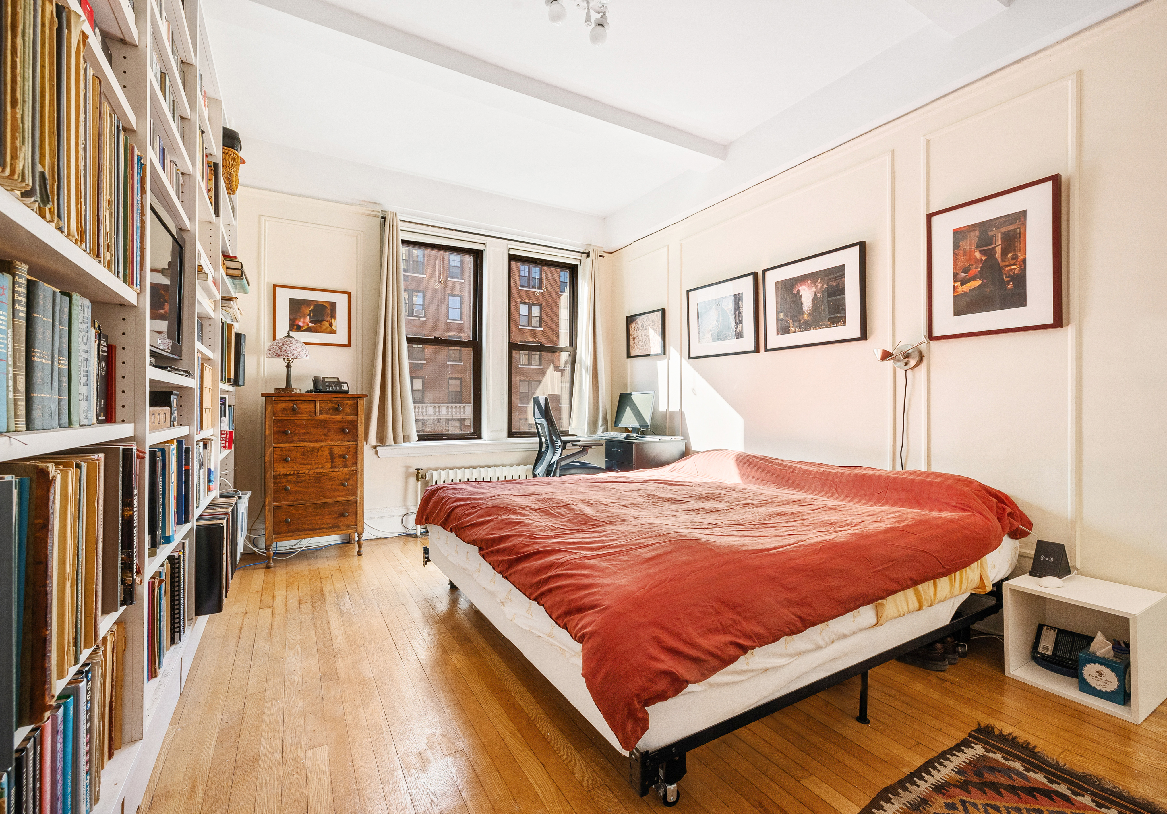 269 West 72nd Street, Unit 9B Manhattan, NY 10023 - Photo 8 of 13 a bed sitting in a bedroom next to a large window
