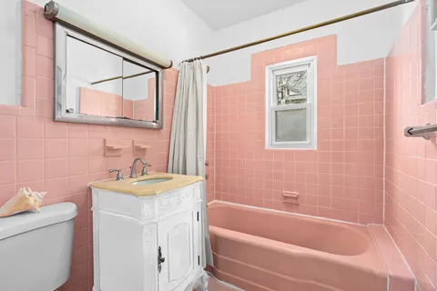 a bathroom with a sink a mirror a bathtub and a shower