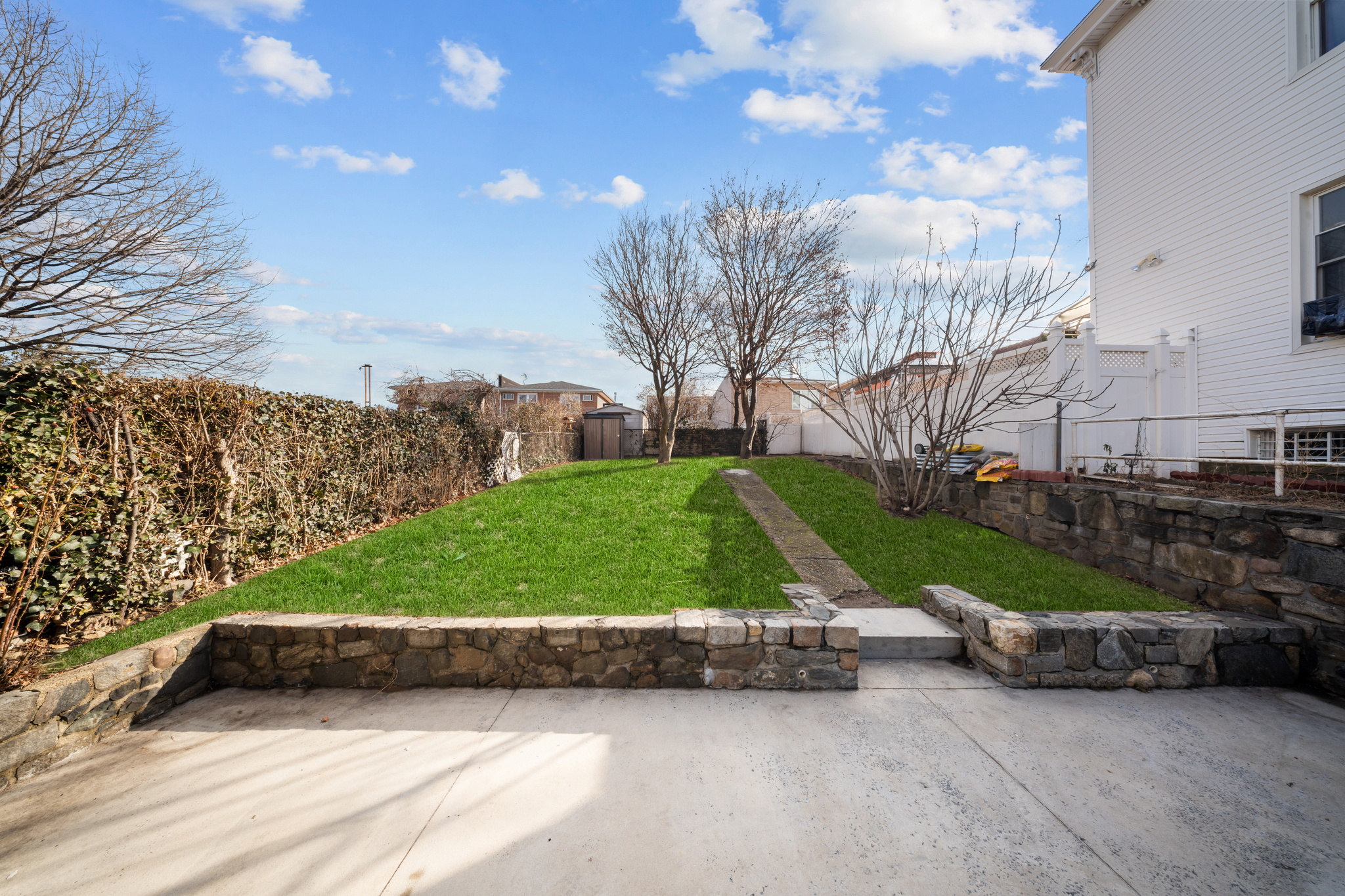 52-19 69th Street Queens, NY 11378 - Photo 30 of 35 a view of backyard with tall trees
