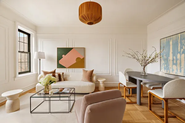 a living room with furniture a table and a large window