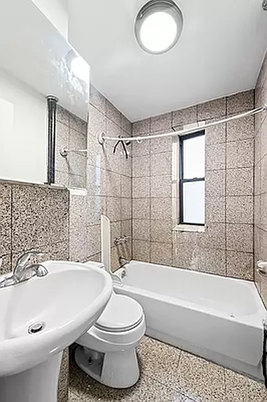 1392 Madison Avenue, Unit 15 Manhattan, NY 10128 - Photo 5 of 5 a bathroom with a sink a toilet and bathtub