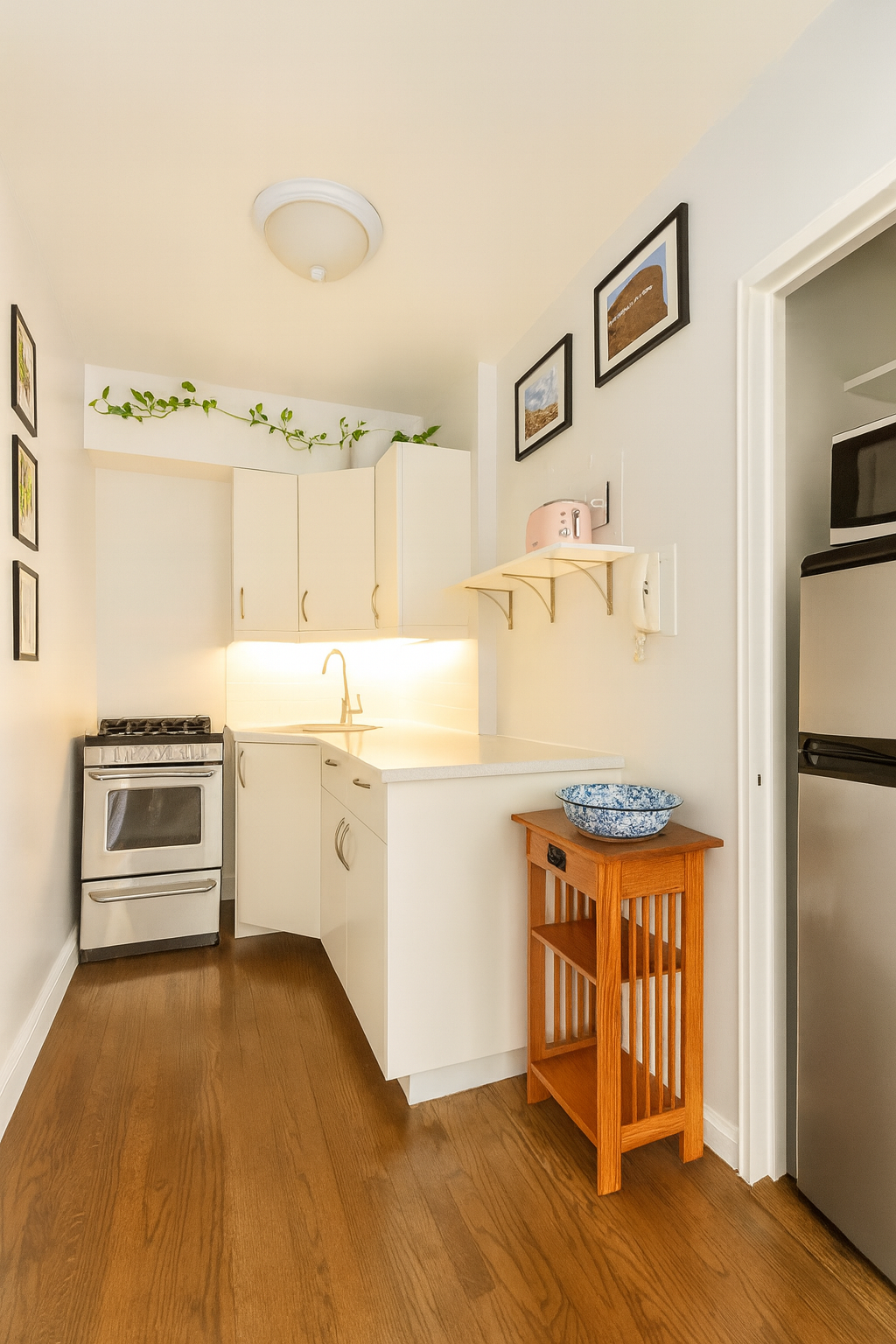 60 East 9th Street, Unit 512 Manhattan, NY 10003 - Photo 3 of 5 a kitchen with a stove a refrigerator and a stove