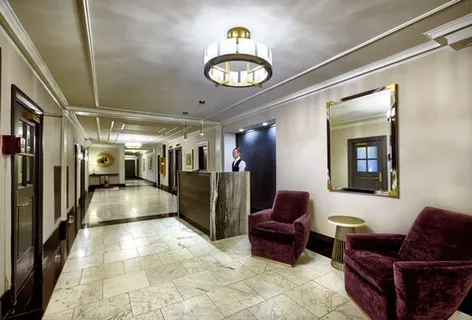 a living room with furniture and a chandelier