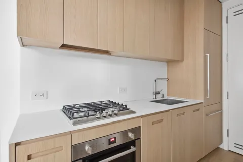 a stove top oven sitting inside of a kitchen