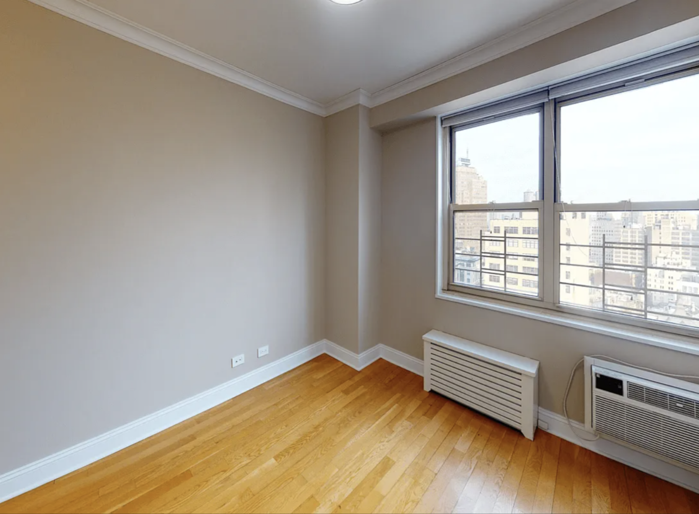 40 Harrison Street, Unit 24H Manhattan, NY 10013 - Photo 16 of 17 a view of a room with wooden floor and a window