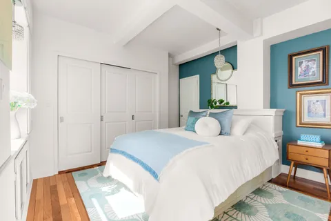 a bedroom with a bed and a chandelier