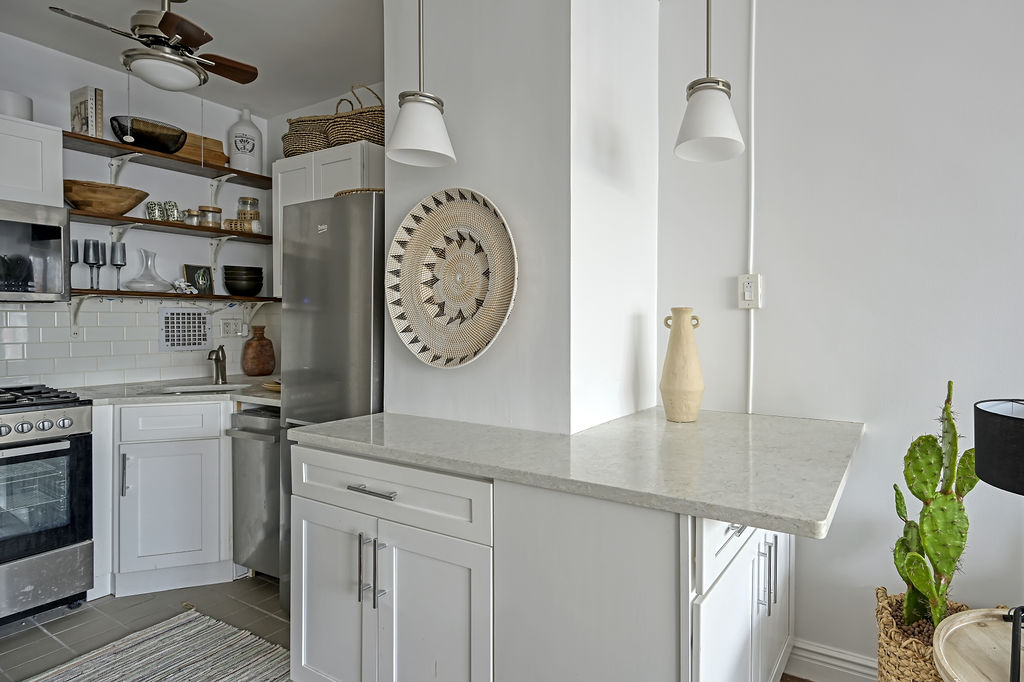 300 East 74th Street, Unit 6D Manhattan, NY 10021 - Photo 5 of 12 a view of a kitchen with washer and dryer