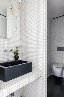 a bathroom with a sink a toilet and mirror