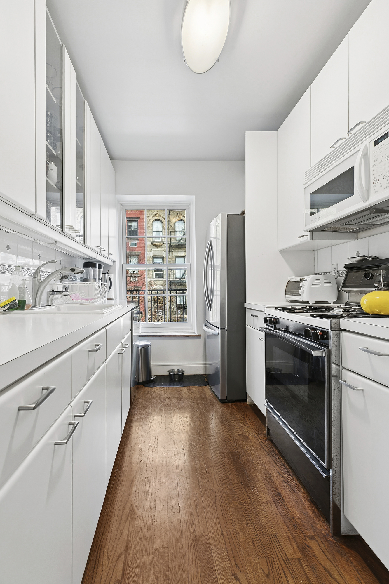 220 East 5th Street, Unit PHE Manhattan, NY 10003 - Photo 4 of 11 a kitchen with a refrigerator and a sink