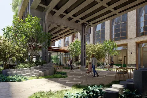 a view of a building with potted plants and large trees