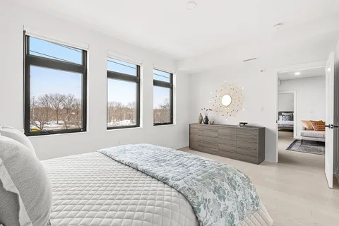 a bedroom with a bed and a dresser