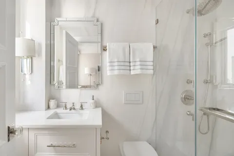 a bathroom with a sink toilet a mirror and shower