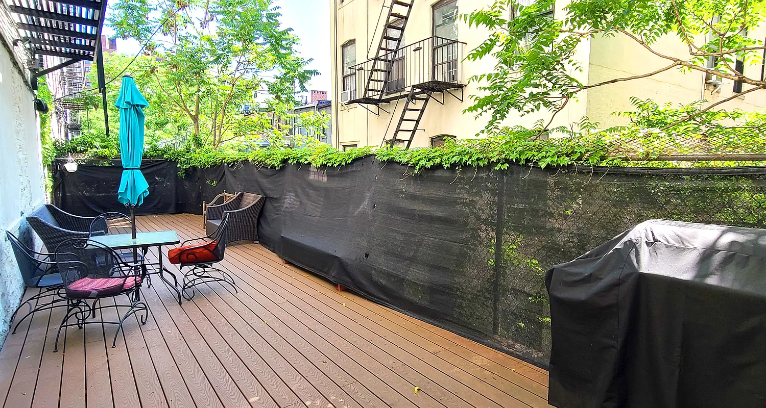 660 St Nicholas Avenue, Unit 63 Manhattan, NY 10030 - Photo 11 of 14 a view of a chairs and table on the wooden deck