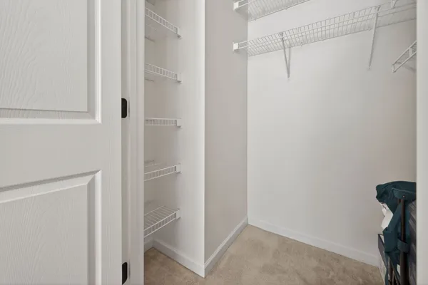 a view of a kitchen cabinets and a refrigerator