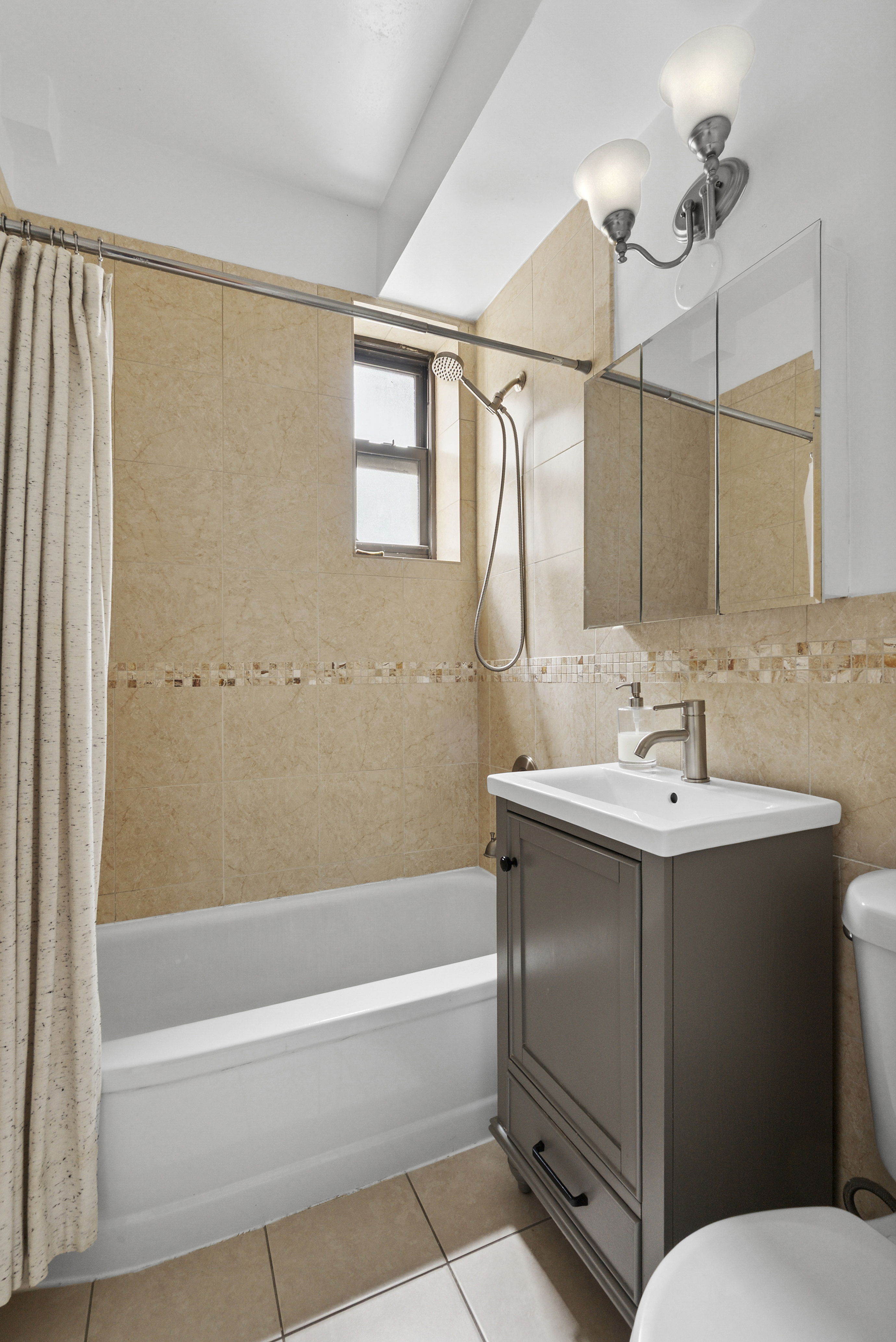 273 Bennett Avenue, Unit 3F Manhattan, NY 10040 - Photo 7 of 9 a bathroom with a sink toilet and shower
