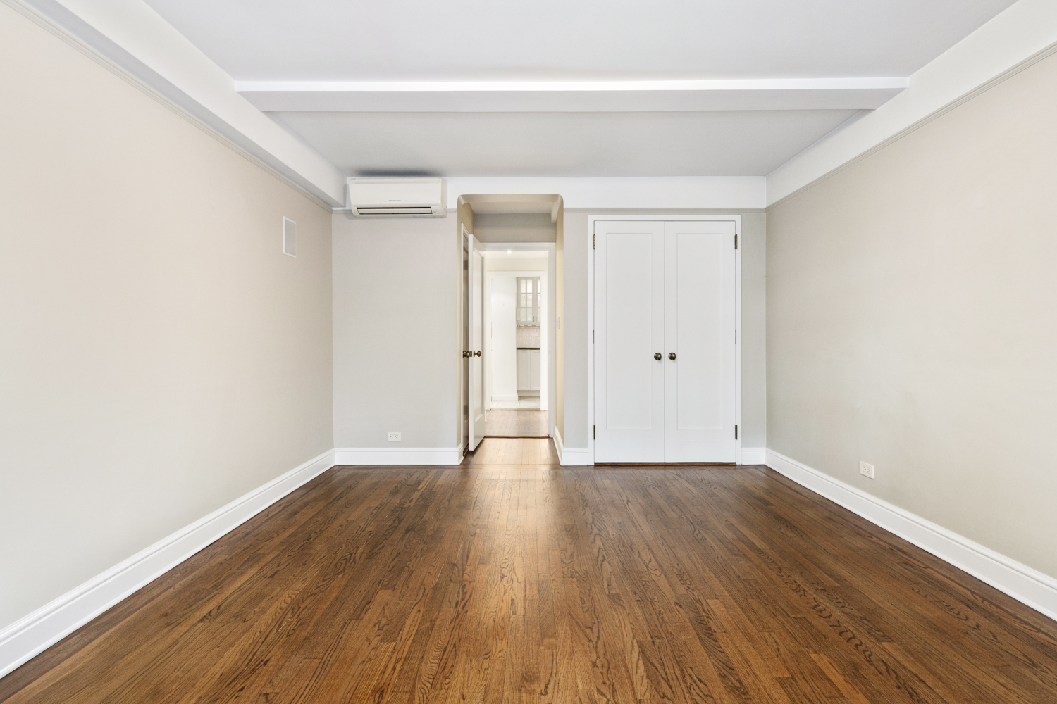 110 East 87th Street, Unit 2C Manhattan, NY 10128 - Photo 10 of 13 a view of an empty room with wooden floor