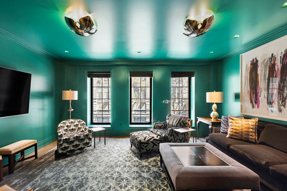 a view of a hallway with wooden floor and a living room