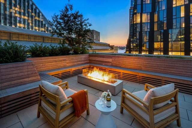 1 West End Avenue, Unit 26G Manhattan, NY 10023 - Photo 31 of 33 a view of a roof deck with couches and wooden floor