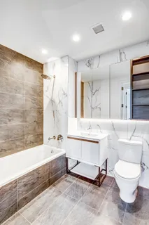 a bathroom with a bathtub shower sink and toilet