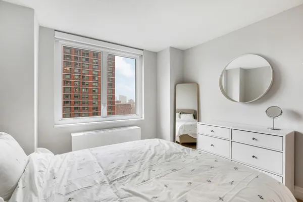 a bedroom with a bed and a dresser