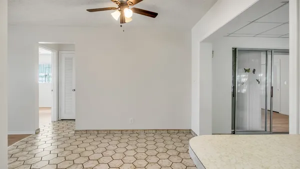 a view of a room with a chandelier fan and closet