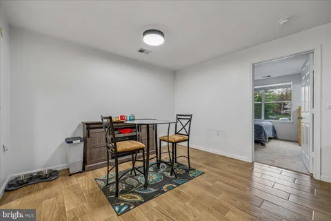 a bedroom with furniture and wooden floor