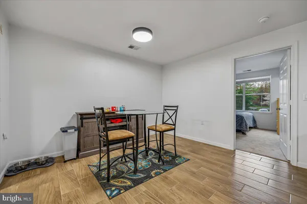 a bedroom with furniture and wooden floor