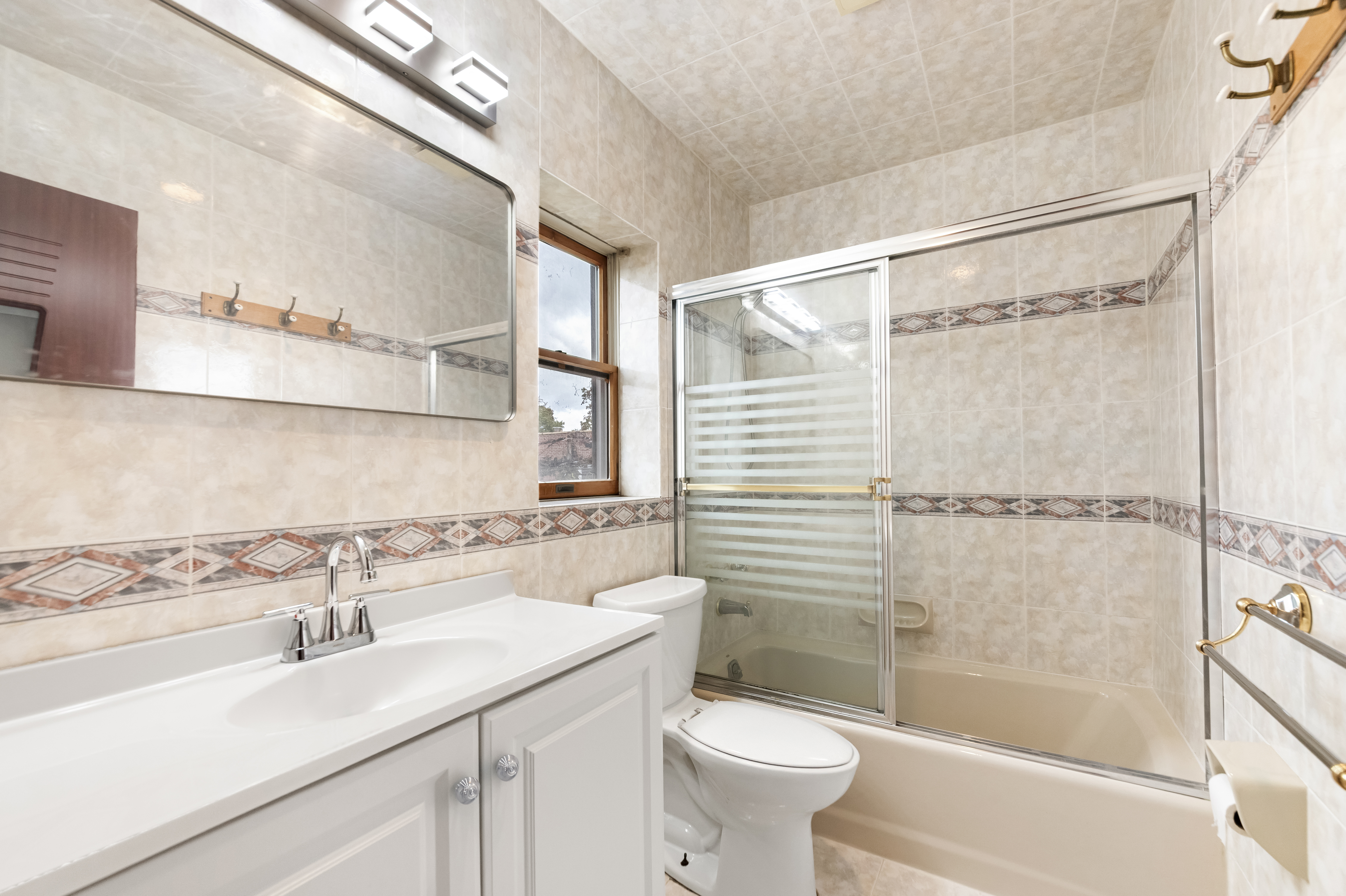 185 Oxford Street Brooklyn, NY 11235 - Photo 9 of 17 a bathroom with a sink mirror toilet and bathtub