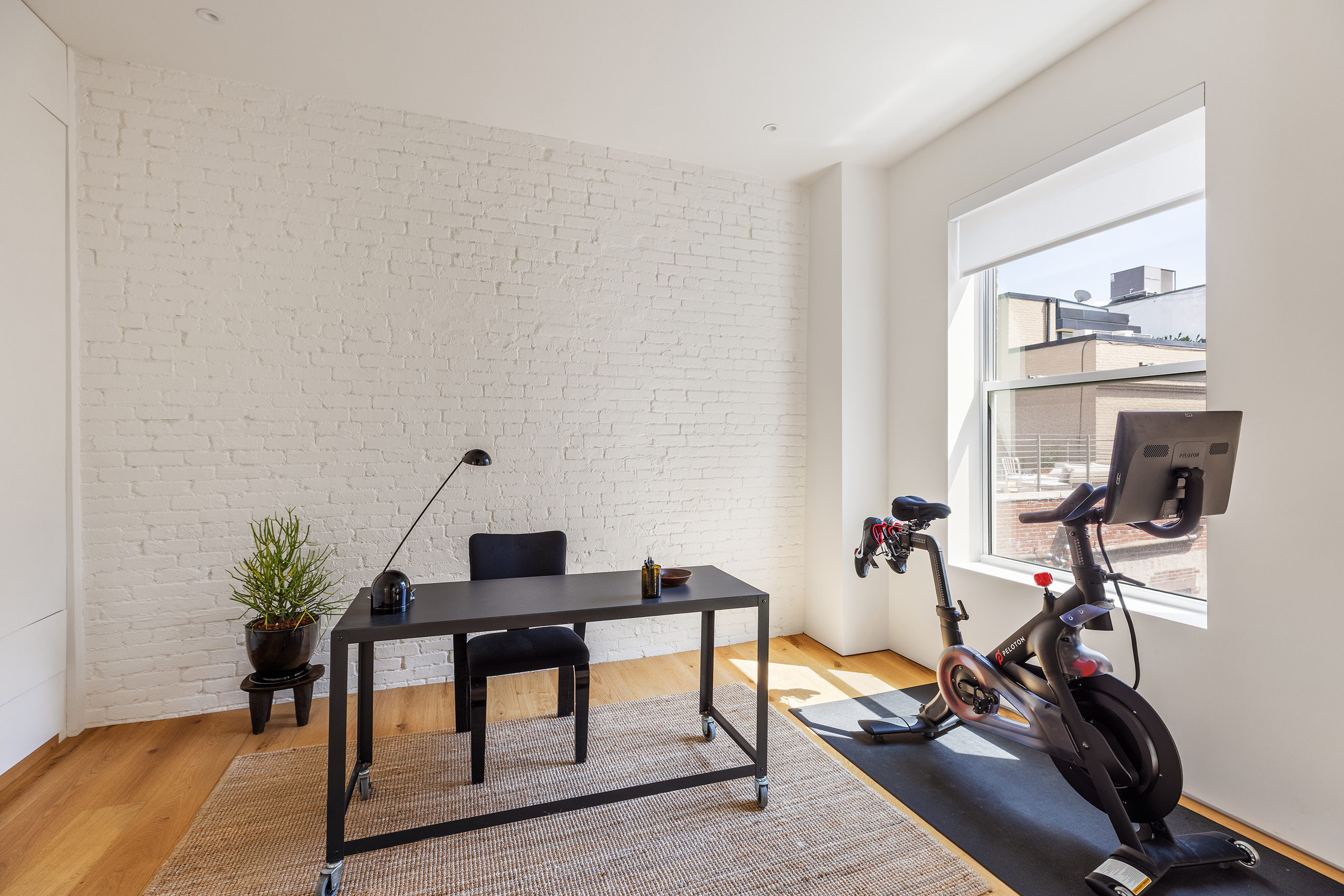 477 Broome Street Manhattan, NY 10013 - Photo 14 of 18 a view of a workspace with furniture and a potted plant