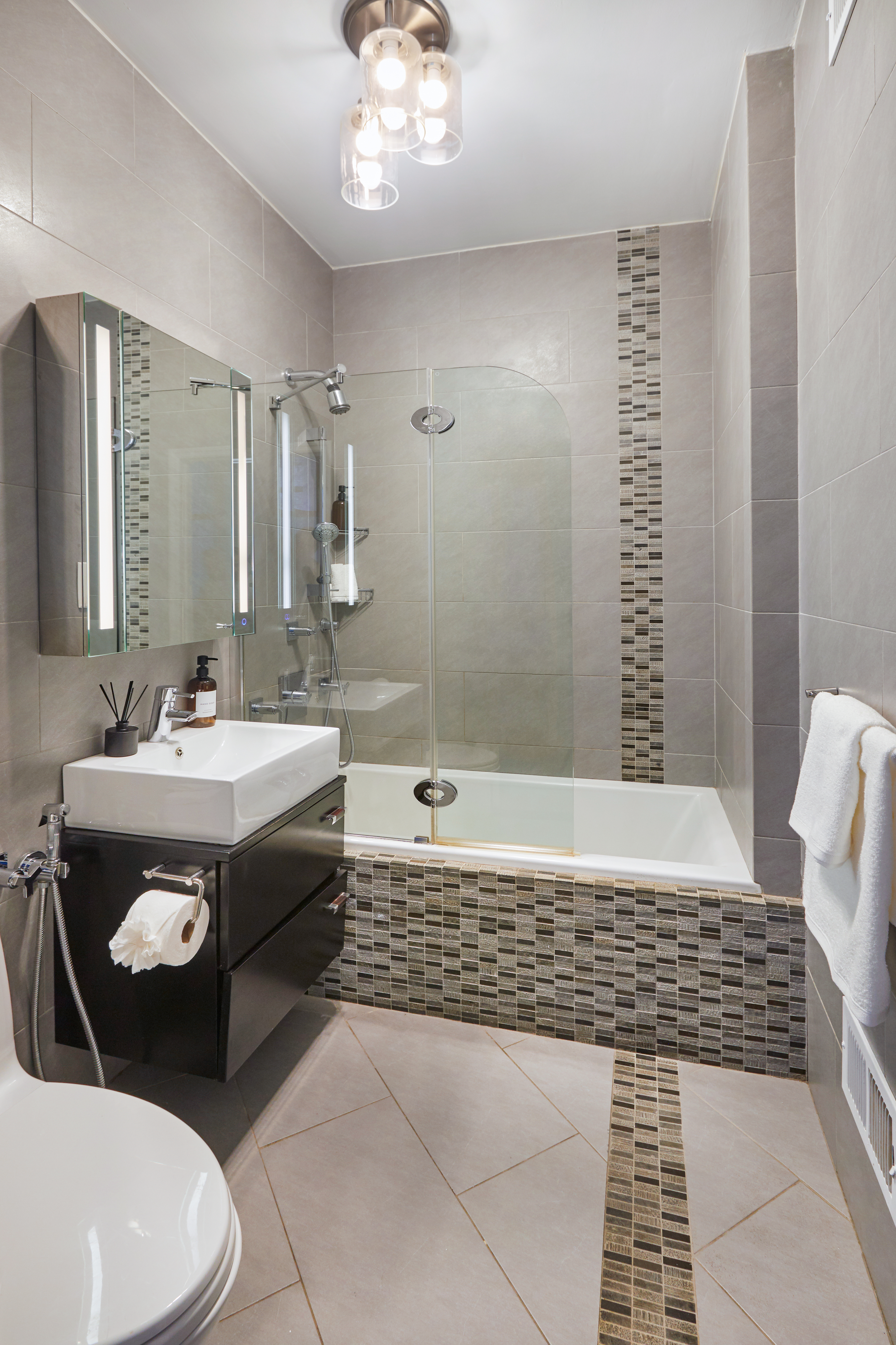 80 Leonard Street, Unit 3G Manhattan, NY 10013 - Photo 24 of 30 a bathroom with a sink a toilet a mirror and shower