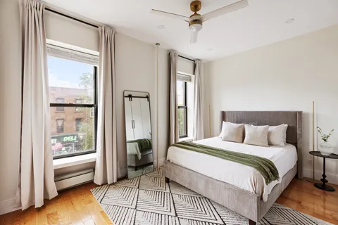 a bedroom with a bed and a chandelier