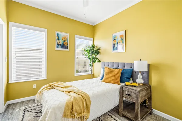 a bedroom with a bed and a potted plant