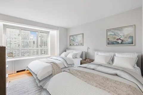 a bedroom with bed and a large window