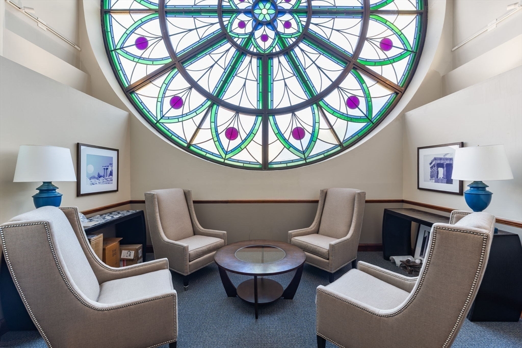 2 Clarendon Street, Unit 401 Boston, MA 02116 - Photo 9 of 13 a living room with furniture and a large window