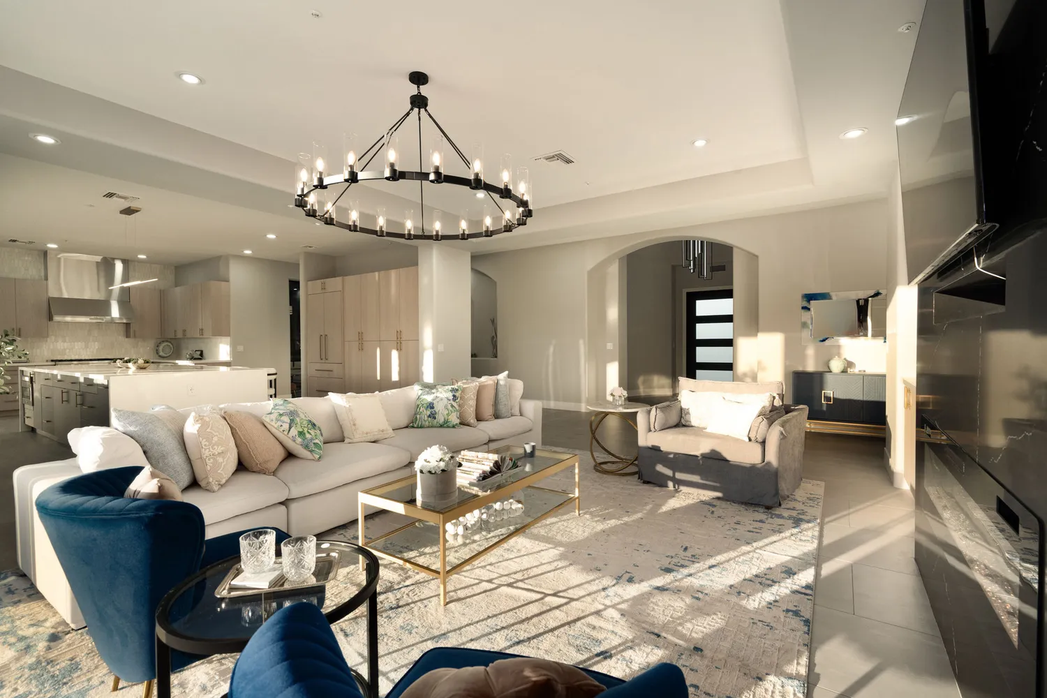 a living room with furniture a flat screen tv and a large window