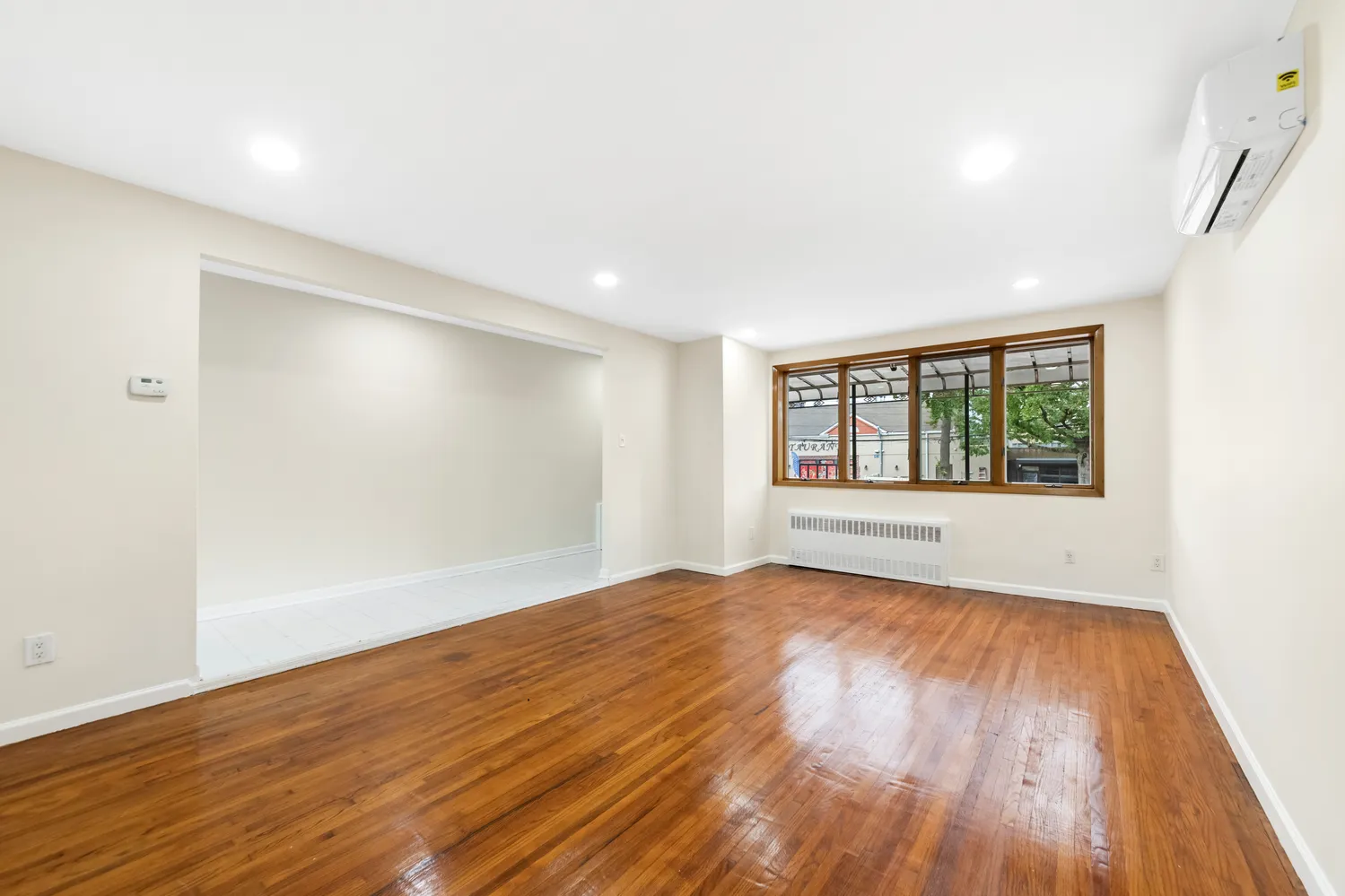 wooden floor in an empty room with a window