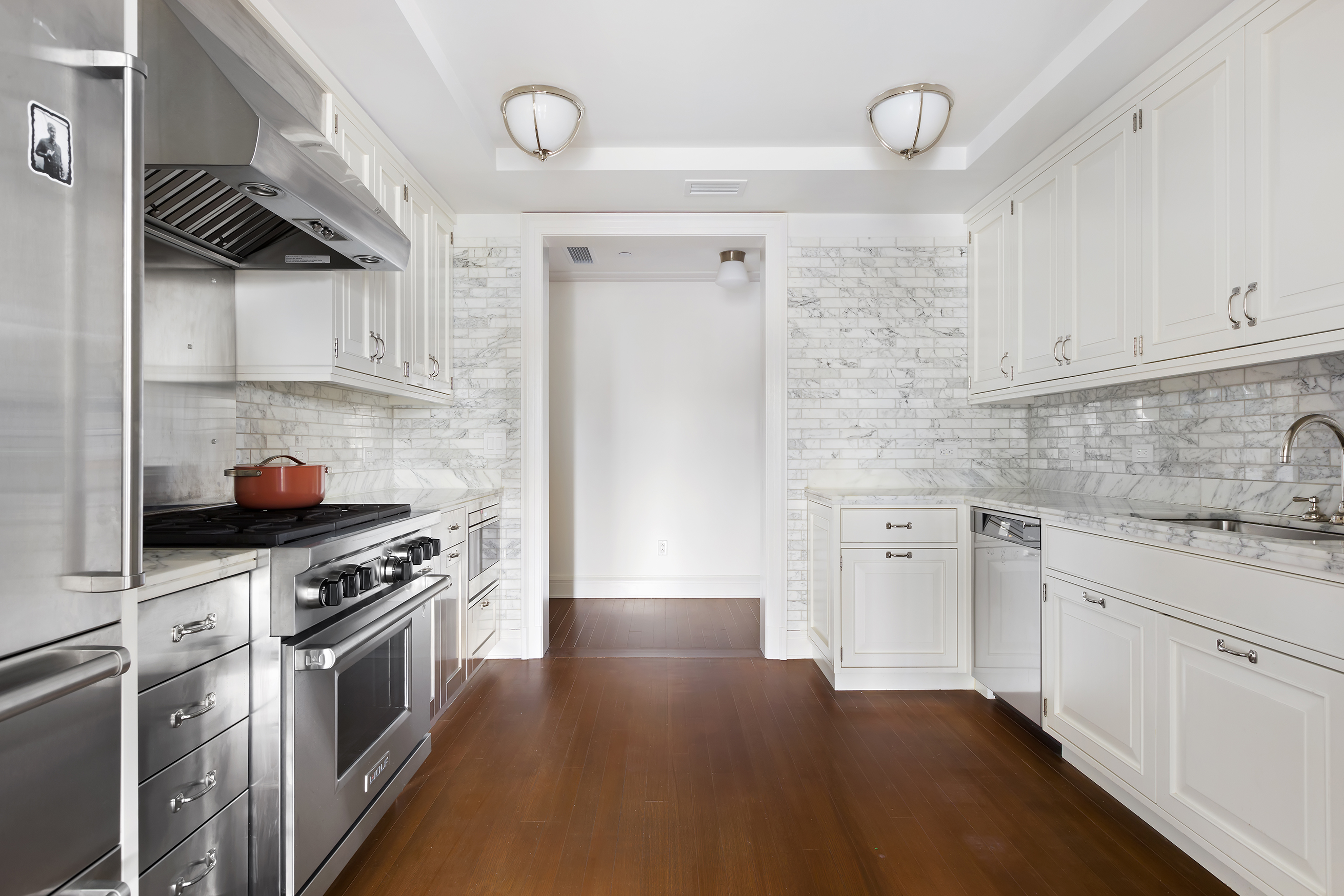 160 West 12th Street, Unit 78 Manhattan, NY 10011 - Photo 7 of 22 a kitchen with stainless steel appliances a stove a sink and cabinets