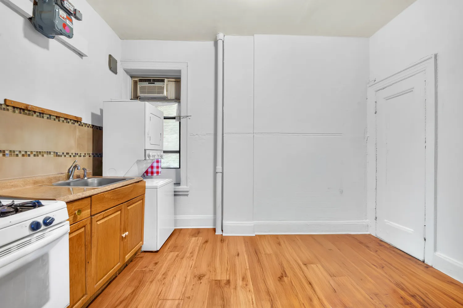 a kitchen with a sink cabinets and wooden floor