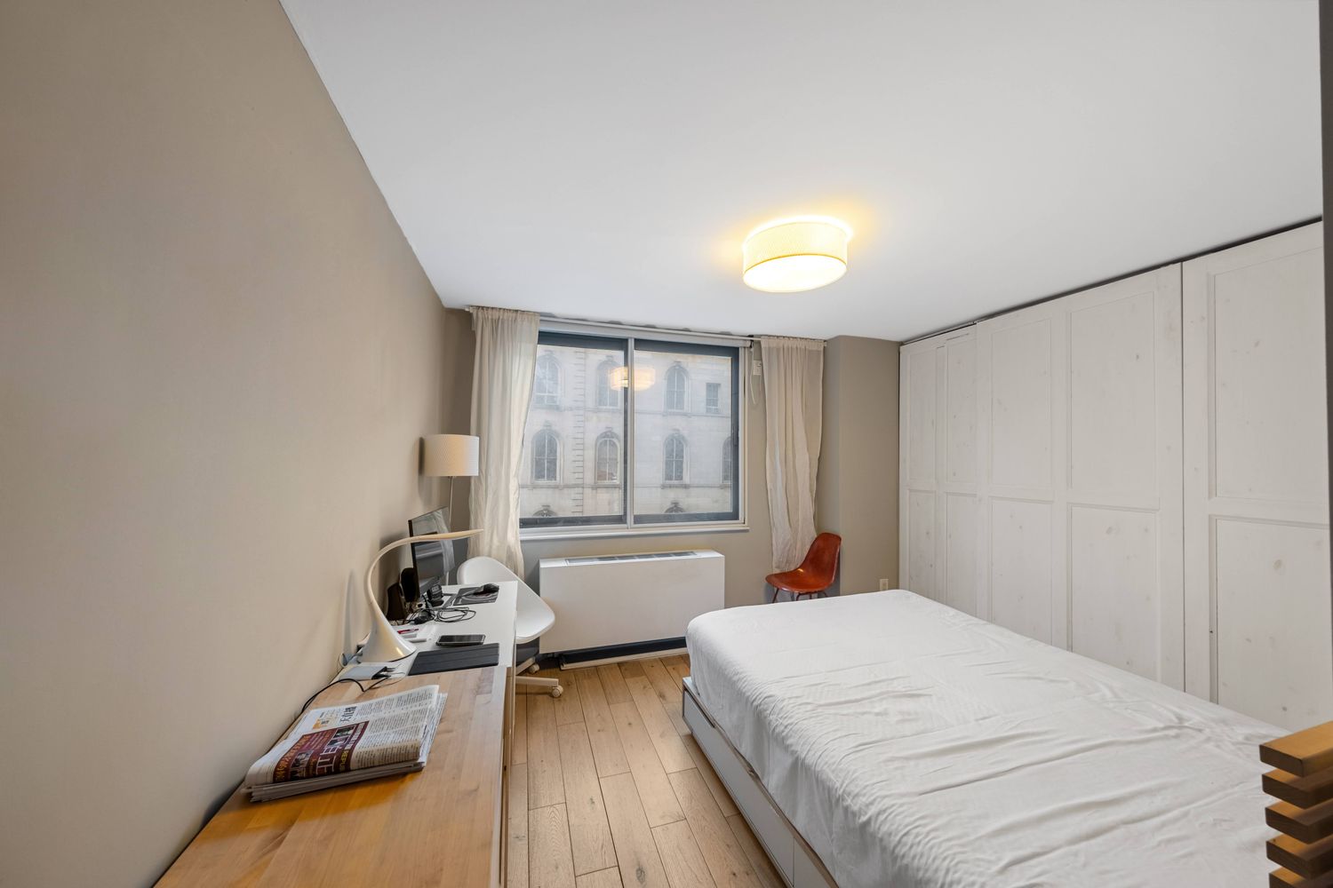 a bed room with a bed and a chair