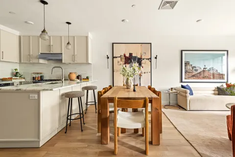 a view of a dining room with furniture and wooden floor