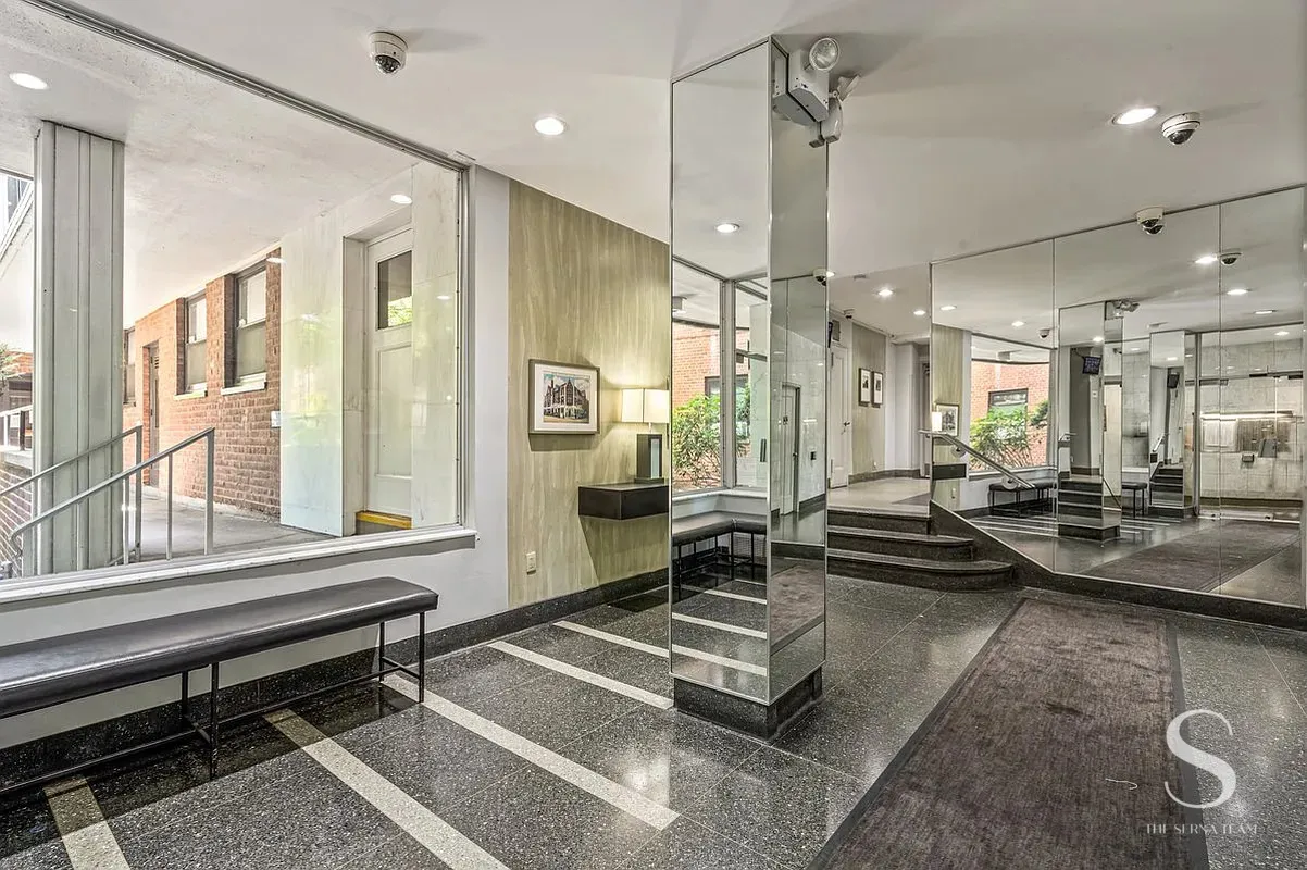 a lobby with furniture and a large window