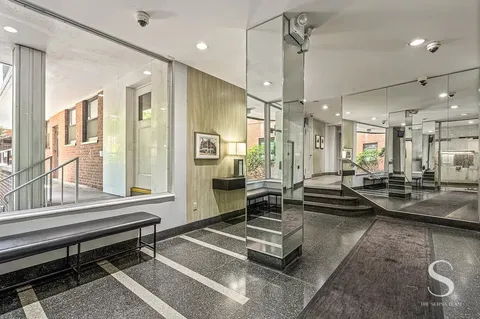 a lobby with furniture and a large window